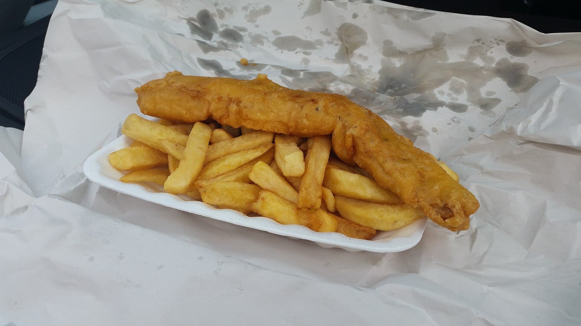 Classic British fish and chips with thick-cut chips and mushy peas — representative image