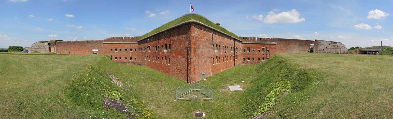 Panoramic view of the red-brick ramparts and grassed ditch of Fort Nelson, near Fareham, Hampshire